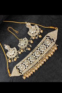 Picture of Spectacular Golden Colored Premium Choker with a pair of Earrings and Mangtikka
